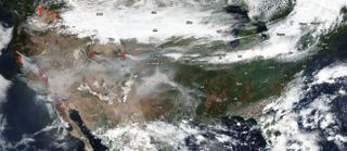 The NOAA/NASA Suomi NPP satellite captured this true-color image of the United States on Sep. 7, 2020, with wildfires marked as bright red dots.