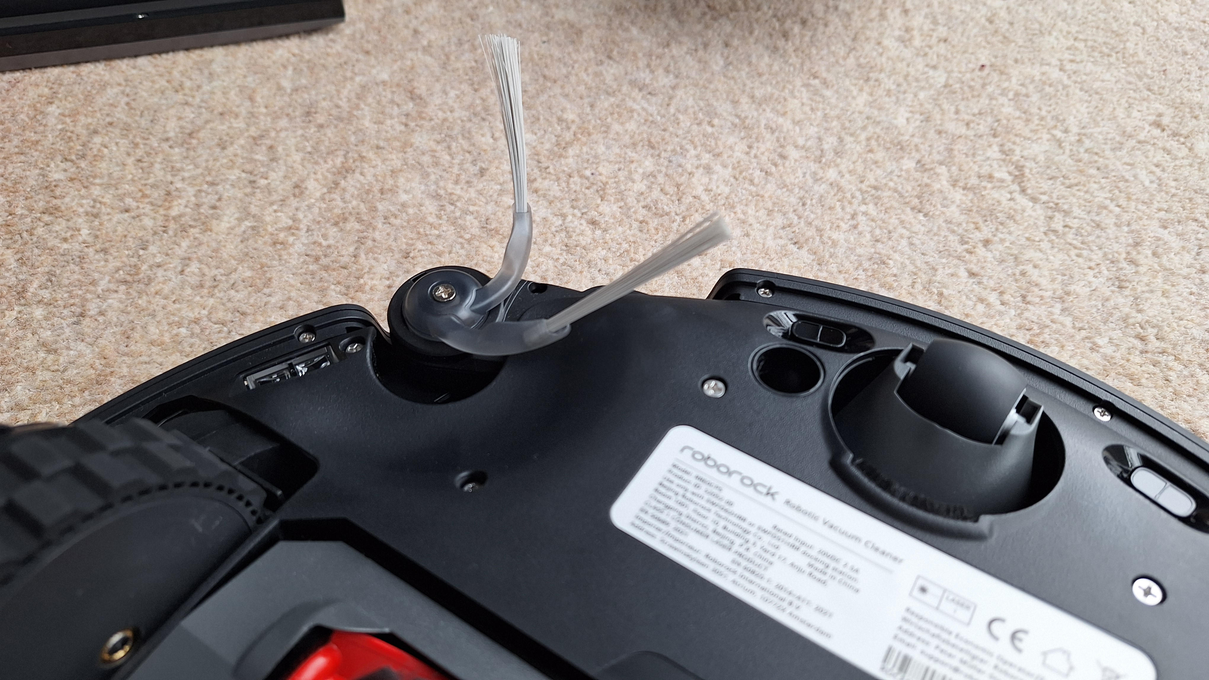 Roborock Saros 20 robot vacuum flipped over to show side sweeper