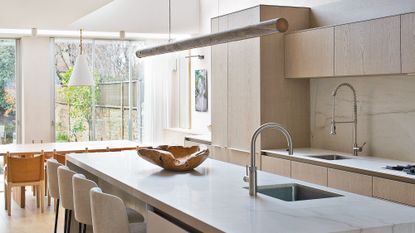 kitchen with marble worktop and wooden cabinets
