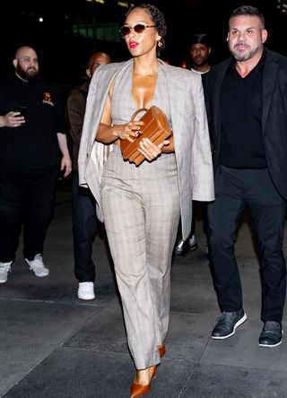 Alicia Keys in suit and tan bag