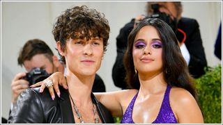 Shawn Mendes wearing an open, leather blazer and Camila Cabello wearing a sparkly purple co-ord as they attend The 2021 Met Gala Celebrating In America: A Lexicon Of Fashion at Metropolitan Museum of Art on September 13, 2021 in New York City