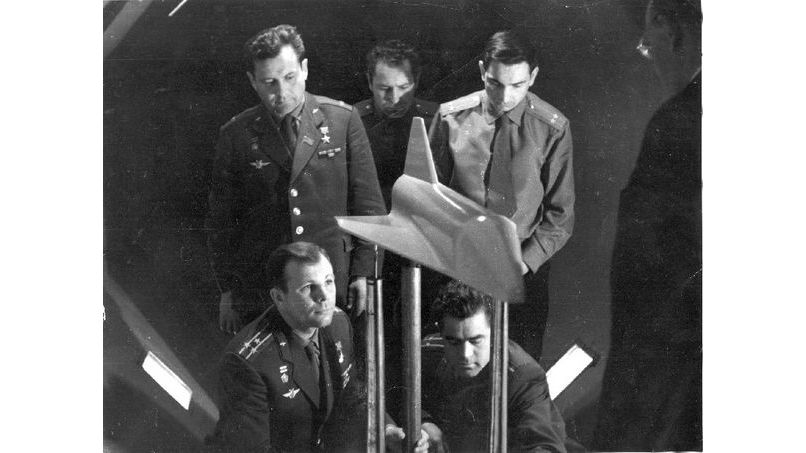 Famed Russian cosmonaut Yuri Gagarin - the first human in space - and others pose for a photo with a model of a winged spacecraft.