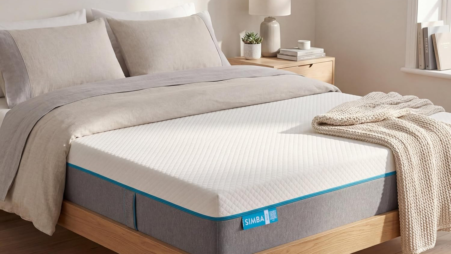 The Simba Simbatex Cool Mattress placed on a wooden bedframe and covered with neutral coloured bed linens and pillows