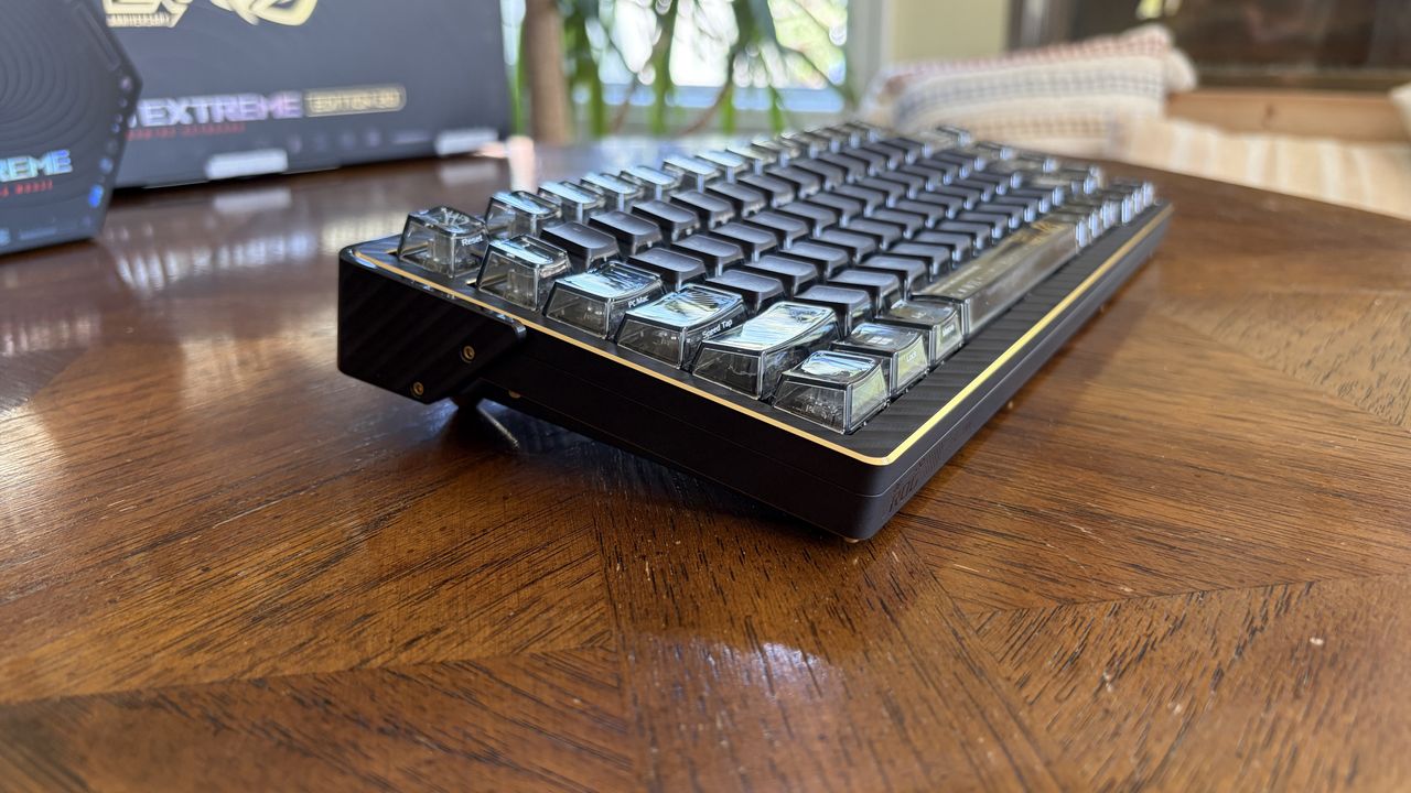 ASUS ROG Azoth Extreme 20 mechanical keyboard with translucent keycaps on a wooden table.