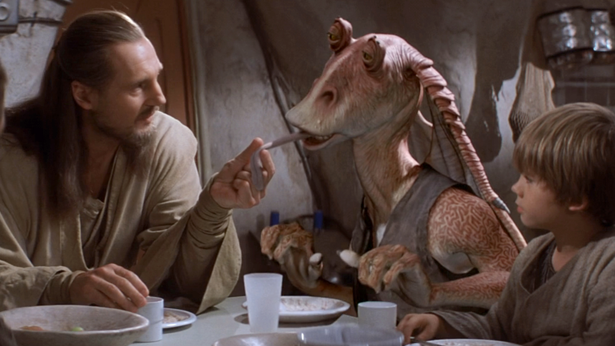 Jar Jar Binks tries to snatch one too many fruits with his frog like tongue only to be stopped by Qui-Gon Gin (Neeson).