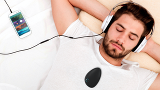 Man with Sensate 2 on chest, listening to sounds from Sensate app