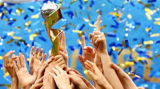 The FIFA Women's World Cup trophy being held aloft by 2019 winners, USA