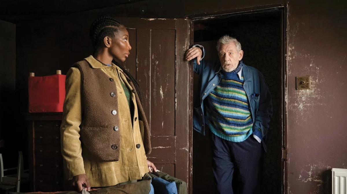 michaela coel looks over her shoulder at ian mckellen leaning against a doorway in a still from the movie the christophers
