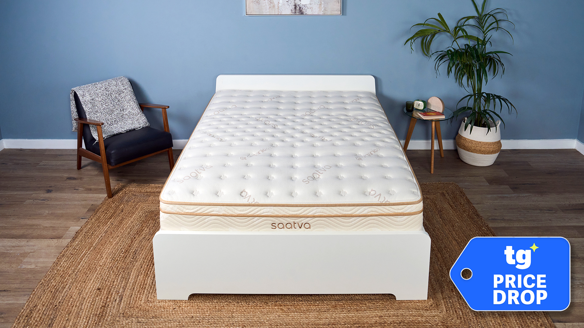 The Saatva Classic mattress on a bed frame in our Tom's Guide Sleep Studio. In the bottom right corner, a Tom's Guide price drop deals badge