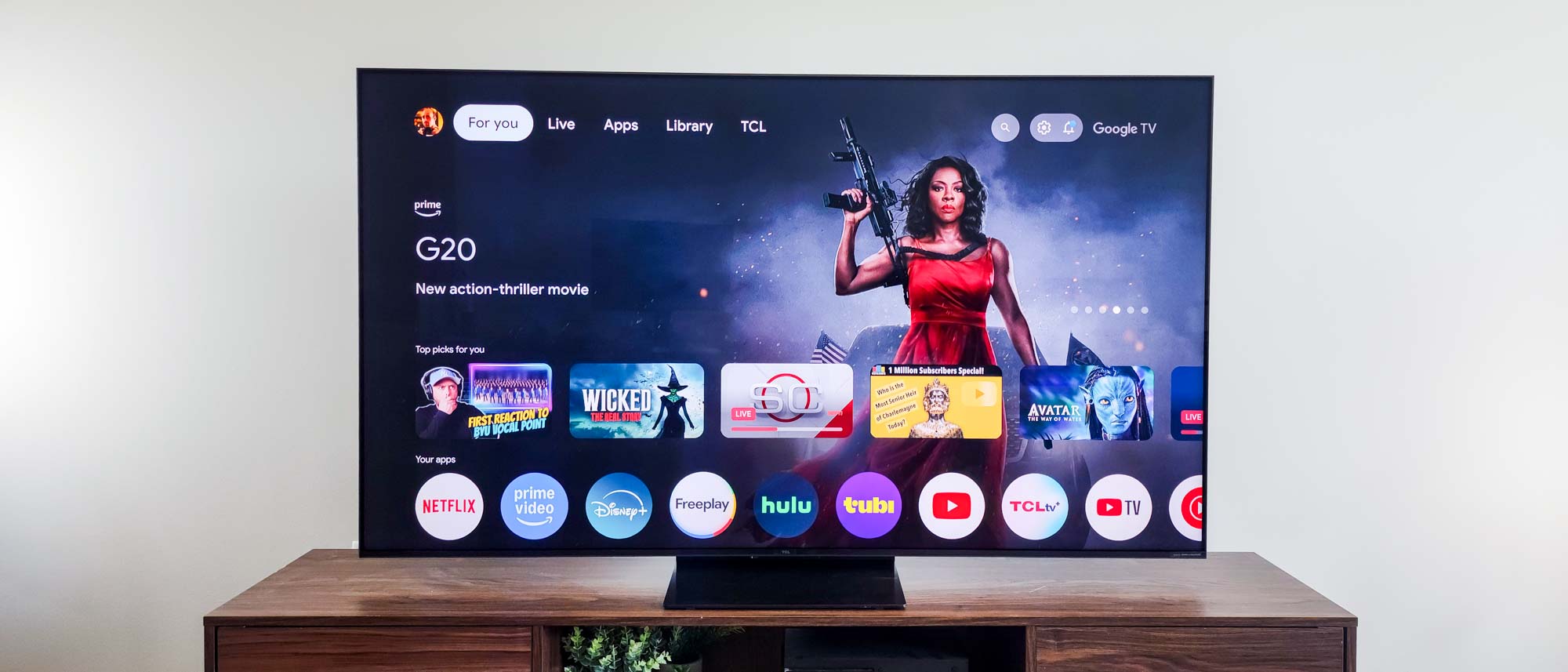 A TCL QM7K QD-Mini LED TV on a side table