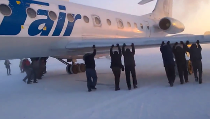 Passengers take plane trouble into their own hands, push plane themselves
