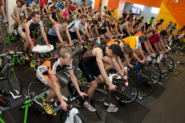 Optum Pro cyclists and Performance members mix for a huge spinning session at Optum Performance.