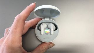 LG Tone Free T90 headphones in case on a silver background