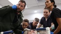 Dr. Michael "Robby" Robinavitch (Noah Wyle, far left) and his fellow doctors anxiously attend to a man undergoing life-threatening difficulties in Season 2 of hit medical drama The Pitt.