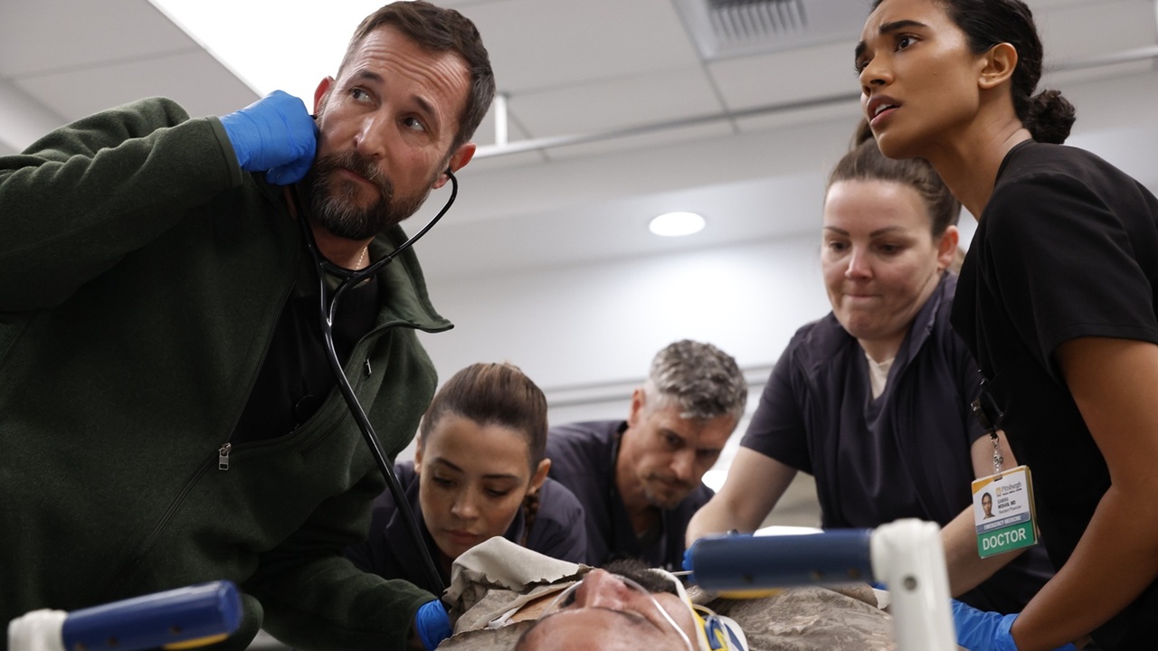 Dr. Michael "Robby" Robinavitch (Noah Wyle, far left) and his fellow doctors anxiously attend to a man undergoing life-threatening difficulties in Season 2 of hit medical drama The Pitt.