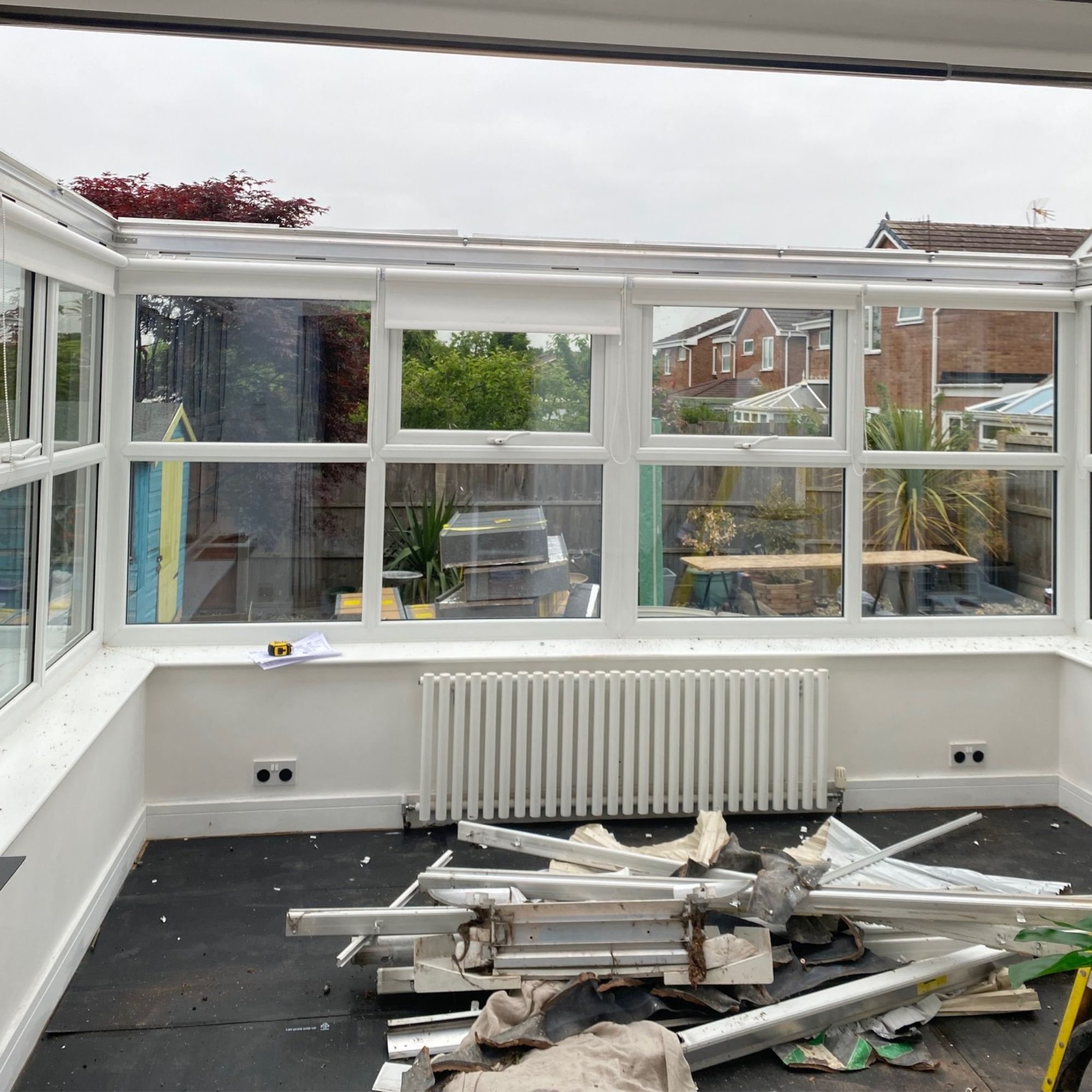The process of the old glass conservatory roof being removed