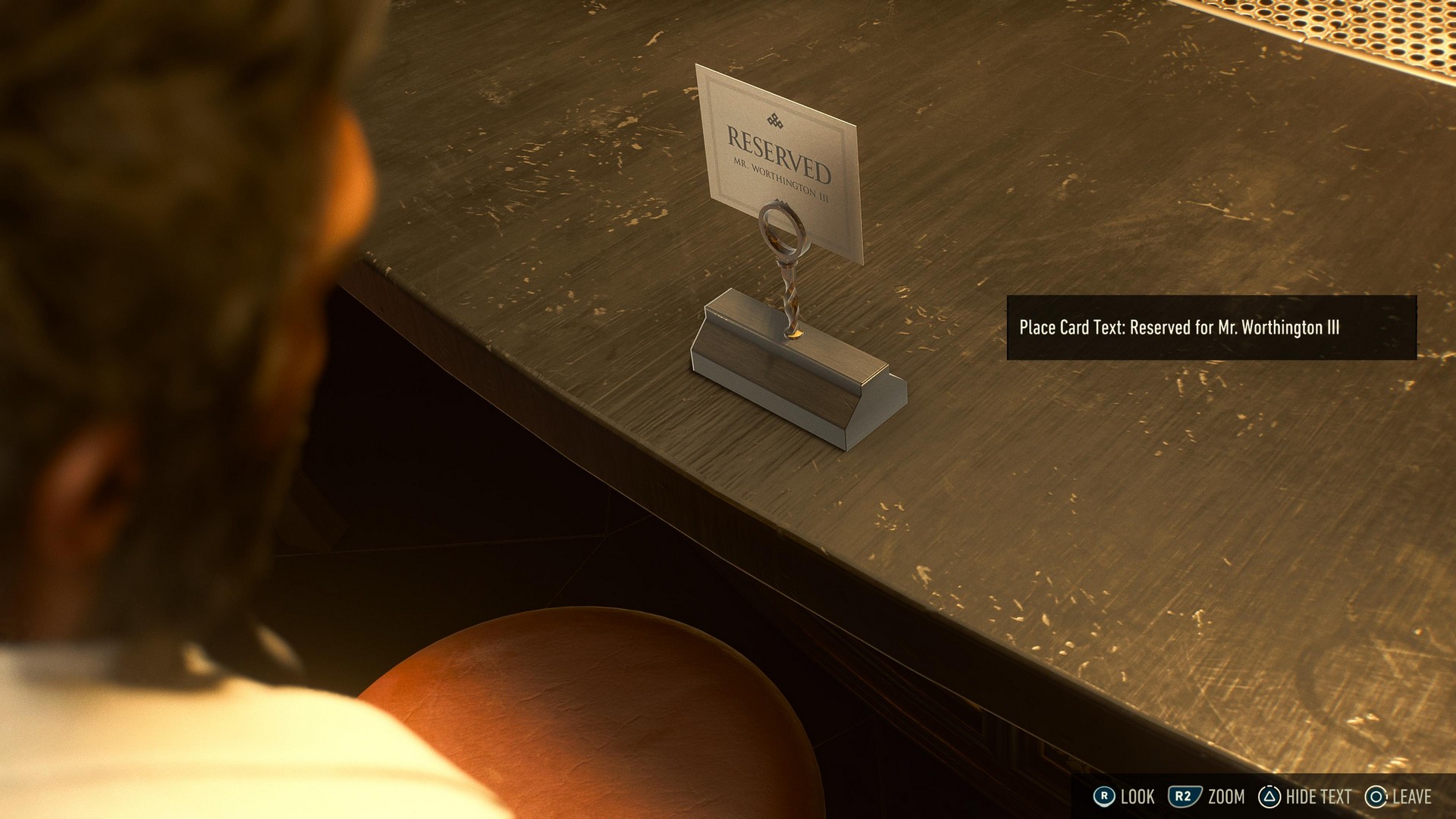 Logan looks at a seat reserved for Worthington III in Marvel's Wolverine within a casino