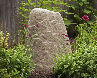 faux rock in garden border for hiding sprinkler valves