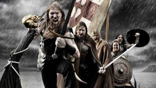 Amon Amarth wielding swords and shields on a longboat in 2009