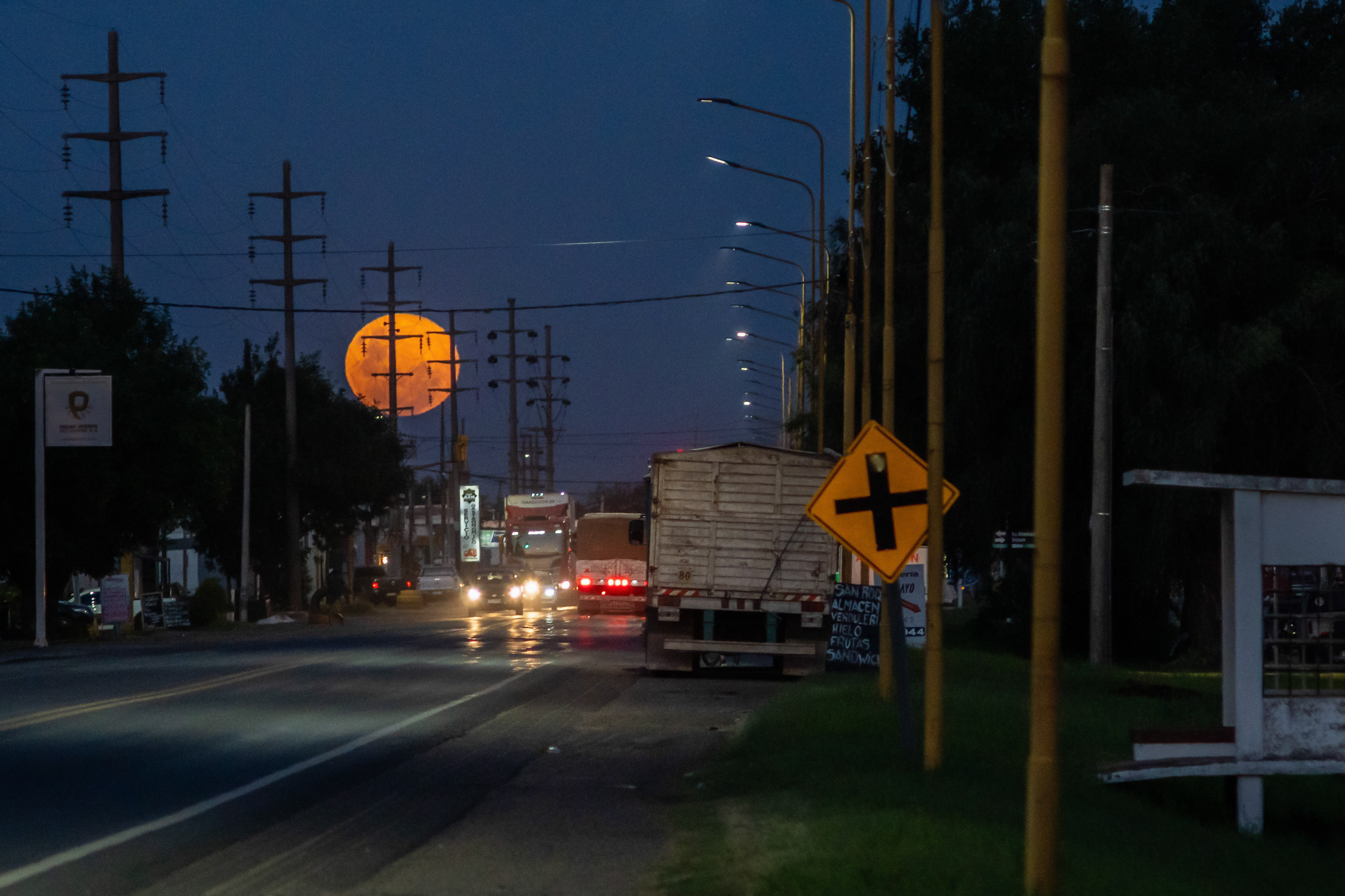 A photo of the &quot;Cold Supermoon&quot; rises over National Route 33 in Firmat, Argentina.