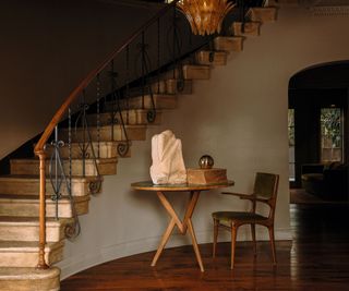 hallway with spiral staircase and round table and chair