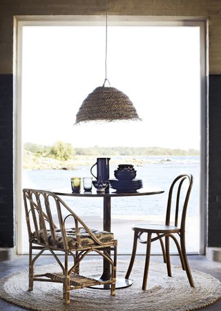 dining room with view of the sea, rattan dining table light