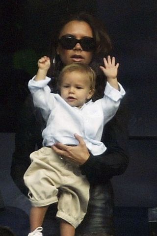 Victoria Beckham holding son Romeo Beckham when he was young