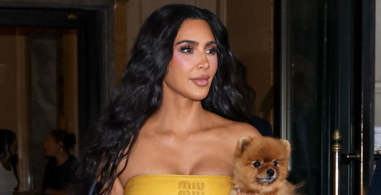 Kim Kardashian is seen leaving The Ritz-Carlton on August 14, 2024 in New York City wearing a mustard miu miu bandana top and her dog sushi