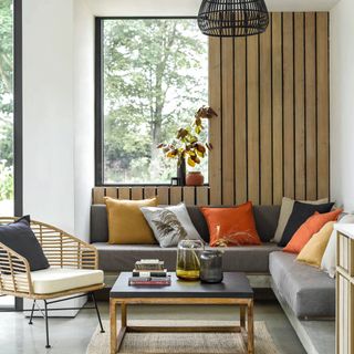 Seating room with wood wall panelling with sofas, cushion, and coffee table