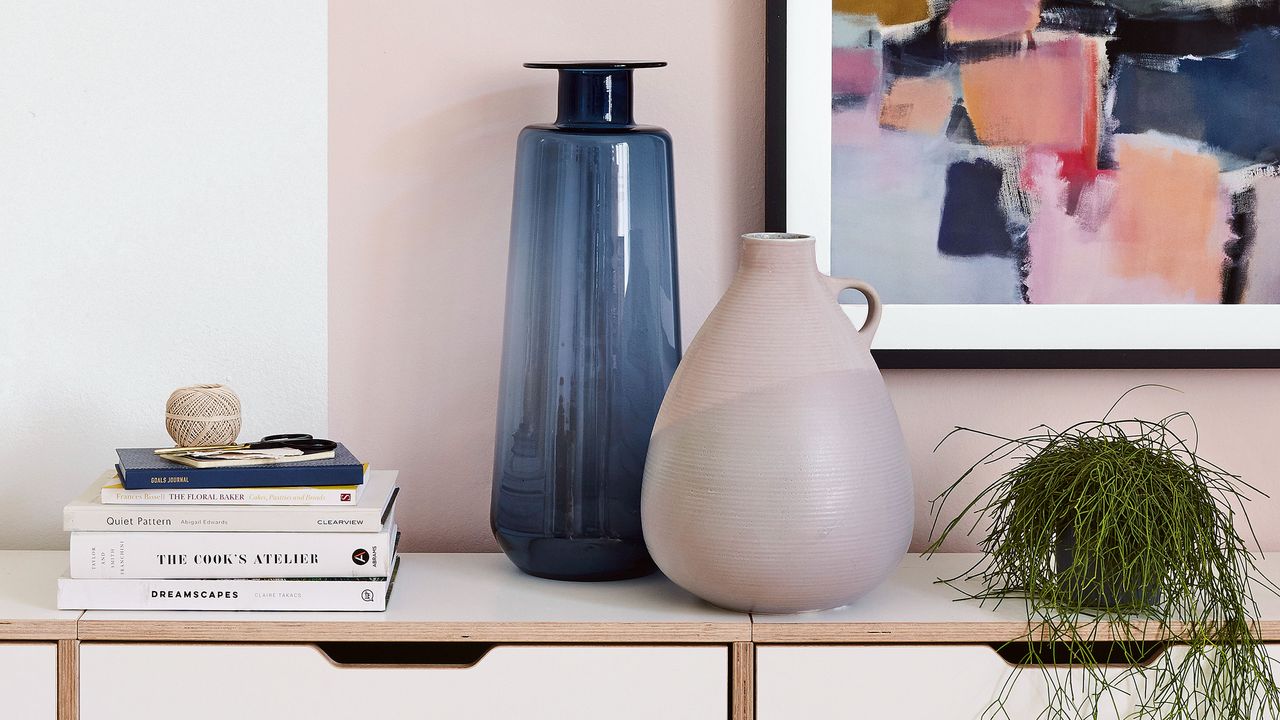 Pink shelf with vase and books