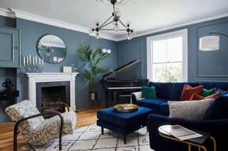 a blue living room with a piano