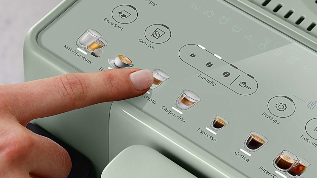 Person pressing button on De'Longhi Rivelia Start coffee maker