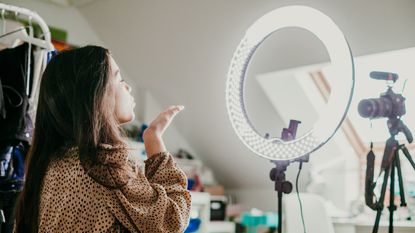gifts for youtubers: vlogger using a ring light and camera