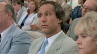 Chevy Chase making a interested look in Fletch Lives
