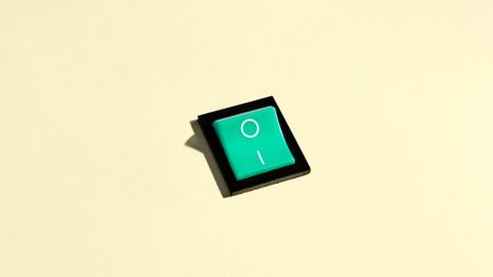 Green switch in the On position on a pastel yellow background