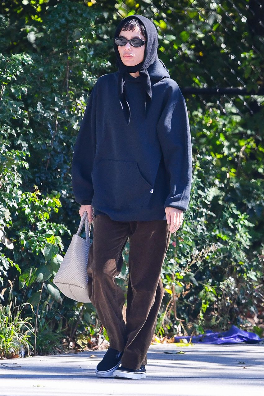 Zoë Kravitz wearing a navy sweatshirt, brown corduroy pants, and black Vans sneakers in NYC