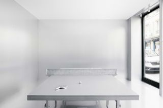 A silver room with a silver ping pong table
