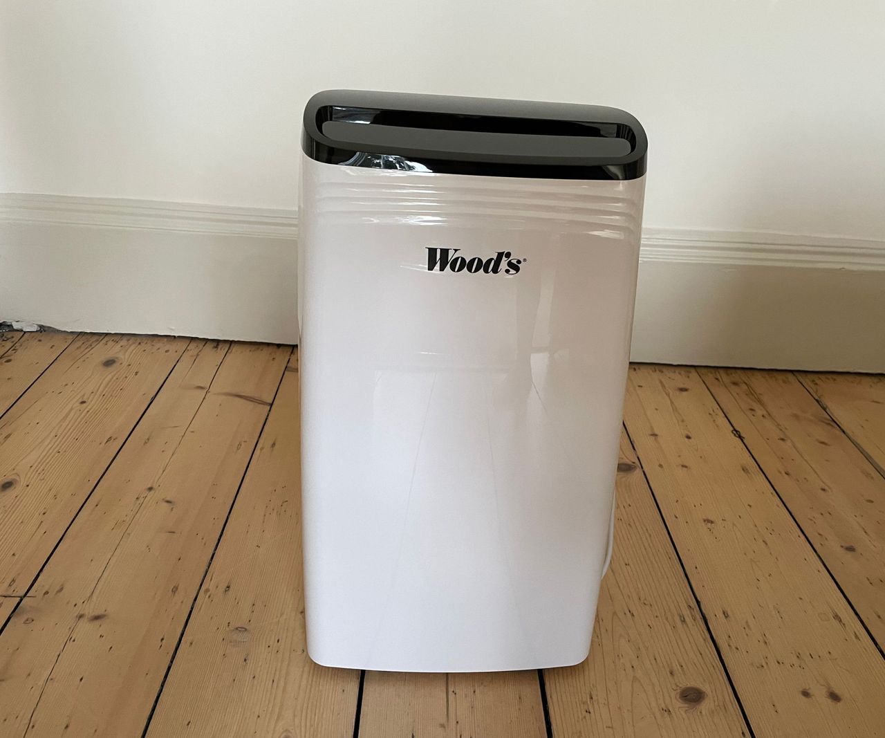 Wood's MDK26 dehumidifier on an oak floor in a lounge