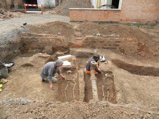 Two Roman burials being excavated from beneath a parking lot in Leicester, England.