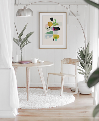 colour geometric art print in an all white dining area with plants
