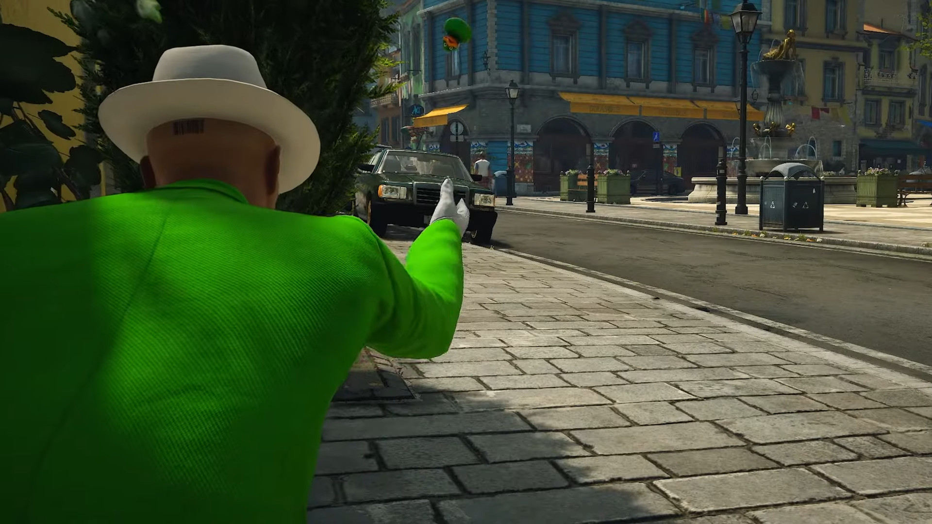 Agent 47 holding a gun while wearing a green suit during one of the best Switch 2 games, Hitman World of Assassination: Signature Edition