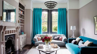 Blue and grey living room ideas with chandelier, grey and turquoise sofas and turquoise curtains