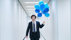 Mark (Adam Scott) holding blue balloons in "Severance" season 2