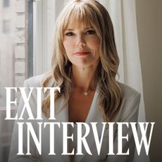 Wendy McMahon wearing a white two piece suit posed seated against a white window