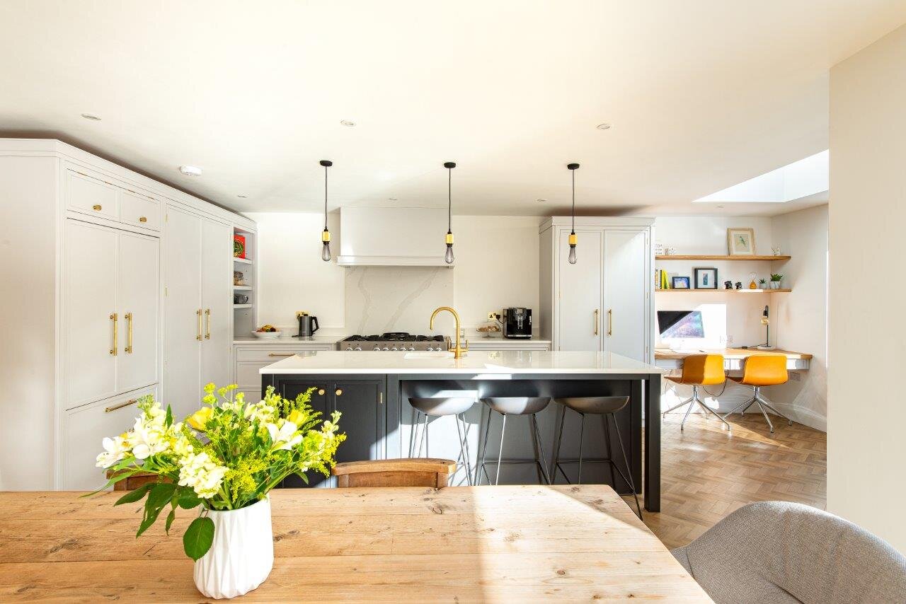 an open plan kitchen with a home office