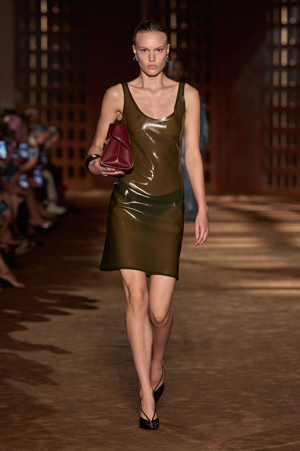 a model wears latex while walking the ferragamo spring 2027 runway.