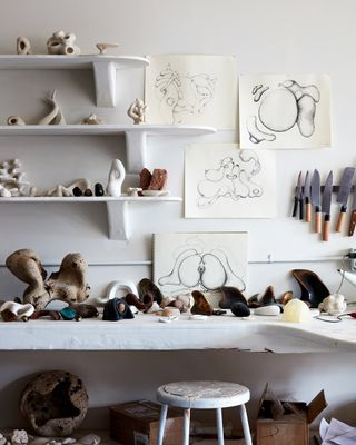 Illustrated studies for fertility forms are seen on the walls alongside maquettes and models for commissions on shelves