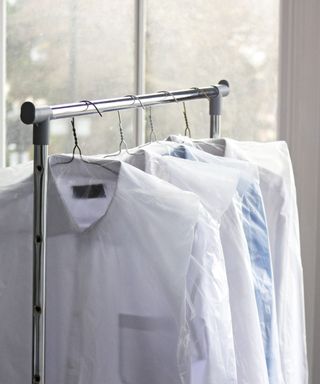 Clothes on a rail in dry cleaning bags