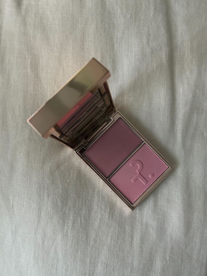 PATRICK TA Major Glow Highlighter on a white linen background