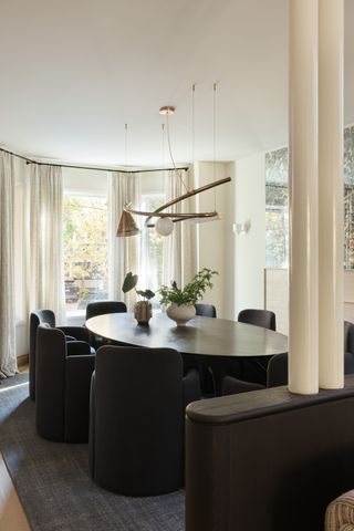 dining room in curved space with black table and chairs